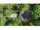 An aerial view of the property shows the home nestled among lush trees with a spacious layout at 2225 E Welch Rd, Apopka, FL 32712