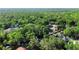 This aerial view showcases a lush green forest in a neighborhood with single Gathering homes at 2225 E Welch Rd, Apopka, FL 32712