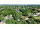 This aerial view highlights the homesite's mature trees and verdant neighborhood with nearby amenities at 2225 E Welch Rd, Apopka, FL 32712