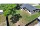 This aerial view of the back yard showcases a large grassy lawn surrounded by trees at 2225 E Welch Rd, Apopka, FL 32712