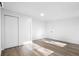 Sun-drenched bedroom with modern laminate floors, closet, and door frame at 2225 E Welch Rd, Apopka, FL 32712