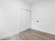 Bedroom with laminate floors, closet, and doorway to other rooms at 2225 E Welch Rd, Apopka, FL 32712
