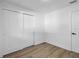 Bright bedroom features sleek laminate floors and a closet for storage at 2225 E Welch Rd, Apopka, FL 32712