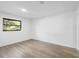 Bright bedroom with laminate floors and a view of the outdoors through a window at 2225 E Welch Rd, Apopka, FL 32712