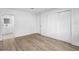 This bedroom features laminate floors, closet, and a doorway leading to the bathroom at 2225 E Welch Rd, Apopka, FL 32712