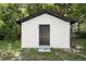 The garage is a detached structure with a black door and white siding at 2225 E Welch Rd, Apopka, FL 32712
