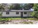 Exterior view of house with dark windows and white walls at 2225 E Welch Rd, Apopka, FL 32712
