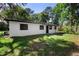 Exterior view of house with dark windows and white walls at 2225 E Welch Rd, Apopka, FL 32712