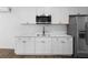 A kitchen with white cabinets and stainless steel appliances at 2225 E Welch Rd, Apopka, FL 32712