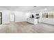 A well-lit kitchen features white cabinets, modern appliances, an island and an open floor plan at 2225 E Welch Rd, Apopka, FL 32712