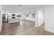 Bright living space featuring white cabinets, stainless steel appliances and a seamless open concept layout at 2225 E Welch Rd, Apopka, FL 32712