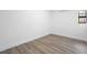 A room with vinyl plank flooring, white walls and trim, and a window at 2225 E Welch Rd, Apopka, FL 32712