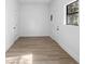 A room with white walls, vinyl plank flooring, and white trim at 2225 E Welch Rd, Apopka, FL 32712