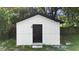 Exterior view of shed with black door and white walls at 2225 E Welch Rd, Apopka, FL 32712