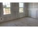 Unfinished bedroom with two windows, allowing natural light at 2286 Broadbrook Dr, St Cloud, FL 34771