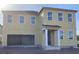 Two-story home featuring a neutral beige siding, white trim, large windows, and a two-car garage at 2286 Broadbrook Dr, St Cloud, FL 34771