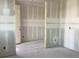 Unfinished room displaying drywall, a door, and modern electrical outlets at 2286 Broadbrook Dr, St Cloud, FL 34771