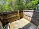 A wood fence encloses a backyard space with concrete flooring and surrounding greenery at 255 Sandlewood Trl, Winter Park, FL 32789