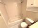 Clean bathroom with a tub-shower, white tiles, and essential fixtures at 255 Sandlewood Trl, Winter Park, FL 32789