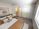 Cozy bedroom with comfortable bed, closet and neutral color scheme at 255 Sandlewood Trl, Winter Park, FL 32789