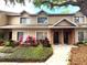 Charming townhome featuring manicured landscaping with colorful plants and an inviting entryway at 255 Sandlewood Trl, Winter Park, FL 32789
