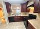 Functional kitchen with wood cabinets and appliances, offering a view to another room at 255 Sandlewood Trl, Winter Park, FL 32789