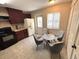 Cozy kitchen featuring dark cabinetry, modern appliances, and a bright dining area at 255 Sandlewood Trl, Winter Park, FL 32789