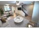 Bright living room featuring a sofa, coffee table, stairs, and dining area at 255 Sandlewood Trl, Winter Park, FL 32789