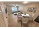 Comfortable living and dining area with tile flooring, modern furniture, and natural light at 255 Sandlewood Trl, Winter Park, FL 32789