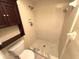 A tiled shower with built-in shelving and a white toilet beside it at 255 Sandlewood Trl, Winter Park, FL 32789