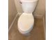 Close-up shot of a white toilet in a bathroom with tiled flooring and trim at 255 Sandlewood Trl, Winter Park, FL 32789