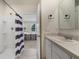 Bathroom with walk-in shower, white sink and a view to the main bedroom at 2827 Turnstone Run, Harmony, FL 34773