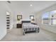 Bright bedroom with a large window, lamps, and an ensuite bathroom at 2827 Turnstone Run, Harmony, FL 34773