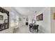 Bright dining area with tiled floors, modern table set, and stylish wall decor at 2827 Turnstone Run, Harmony, FL 34773