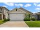 Charming single-Gathering home featuring a two-car garage and well-maintained front lawn at 2827 Turnstone Run, Harmony, FL 34773