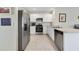 Bright kitchen featuring stainless steel appliances and white cabinetry at 2827 Turnstone Run, Harmony, FL 34773