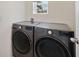 Modern laundry room with gray LG front-loading washer and dryer at 2827 Turnstone Run, Harmony, FL 34773