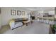 Comfortable living room with a large sectional sofa, carpet, and open access to the kitchen at 2827 Turnstone Run, Harmony, FL 34773