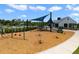 Community playground featuring swings, slides, and climbing structures near a clubhouse building at 2827 Turnstone Run, Harmony, FL 34773