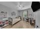 Cozy bedroom with light wood floors and plenty of natural light from large window at 2914 Clarabelle Ct, Kissimmee, FL 34743