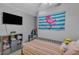 Bright bedroom with grey walls, new vinyl floors, and fun colorful decor at 2914 Clarabelle Ct, Kissimmee, FL 34743