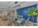 Elegant dining room with a modern light fixture, hardwood floors, and a statement blue wall creating a stylish space at 2914 Clarabelle Ct, Kissimmee, FL 34743