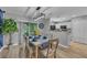 Stylish dining area featuring modern lighting, a dining table set for six, and a sliding door to outside at 2914 Clarabelle Ct, Kissimmee, FL 34743