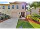 Charming two-story townhome featuring a one-car garage, manicured lawn, and vibrant landscaping at 2914 Clarabelle Ct, Kissimmee, FL 34743