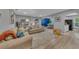 Bright and spacious living room with neutral tones, hardwood floors, and comfortable seating arrangement at 2914 Clarabelle Ct, Kissimmee, FL 34743