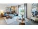 Open-concept living room with large sectional sofa, modern art, and sliding glass doors at 2915 Canary Ave, Davenport, FL 33837