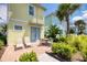 Cozy outdoor patio with brick pavers, seating, manicured garden, and tropical landscaping at 2978 Latitude Ln, Kissimmee, FL 34747
