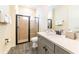 Well-appointed bathroom with a glass-enclosed shower, gray vanity with quartz countertop, and modern fixtures at 2978 Latitude Ln, Kissimmee, FL 34747