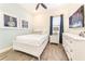 Stylish bedroom with white furnishings, nautical decor, wood-look tile flooring, and ample natural light at 2978 Latitude Ln, Kissimmee, FL 34747