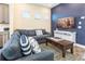 Comfortable living room with a large gray sectional, decorative pillows, a modern TV, and stylish furnishings at 2978 Latitude Ln, Kissimmee, FL 34747